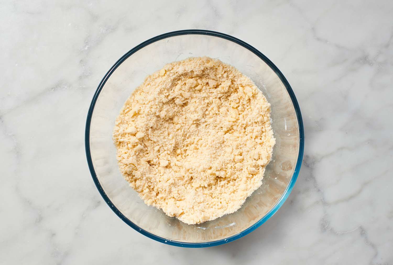 A bowl of coarse flour, salt, and butter mixture