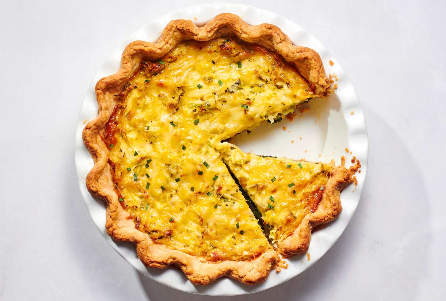 A coronation quiche garnished with tarragon