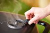 Closeup of a hand moving the smoke vent on the PK Grills PKGo Camp & Tailgate Grilling System