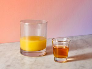 A rocks glass of orange juice and 7-Up and a shot glass of amaretto and Southern Comfort