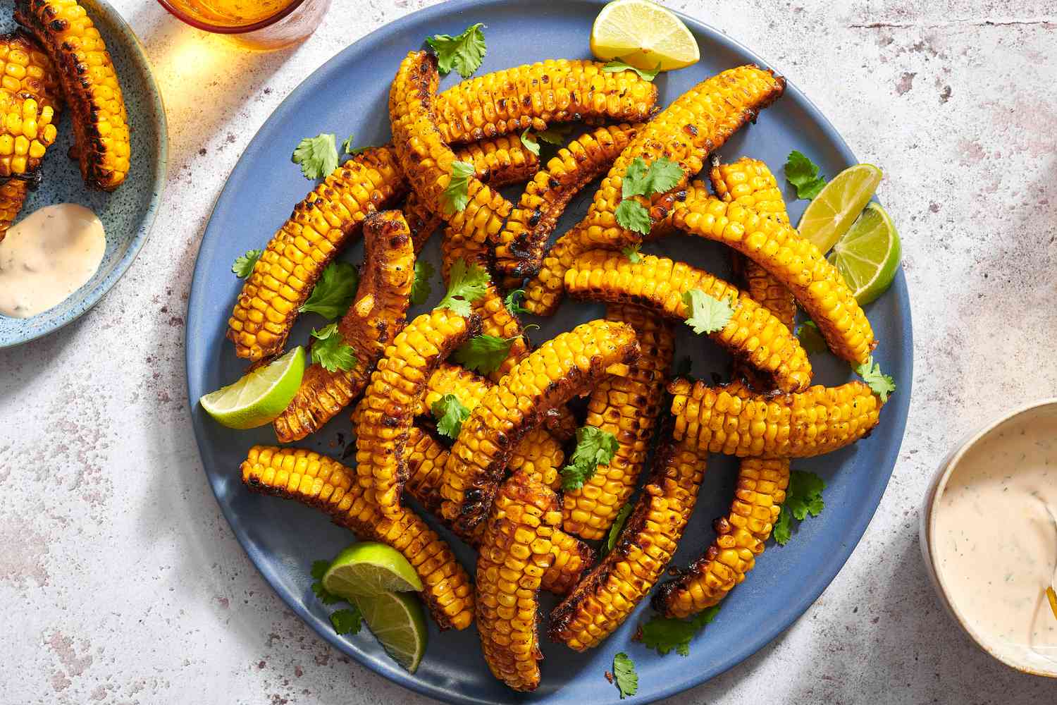 Grilled corn ribs with chipotle honey sauce on a blue platter