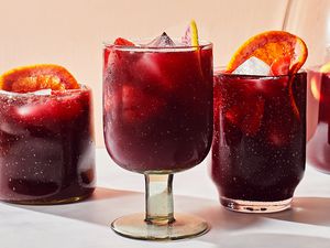 Three glasses of hard seltzer sangria garnished with orange slices