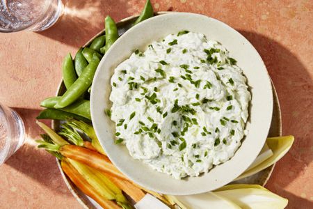 Platter with bowl filled with Benedictine Spread surrounded by cut veggies