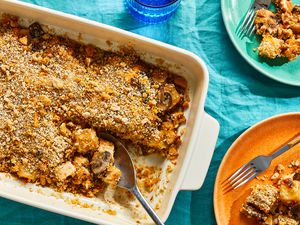 A leftover chicken and potato casserole with two plated portions and a glass of water