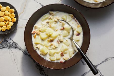 A bowl of New England clam chowder served with oyster crackers