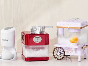 Best snow cone makers displayed on a white surface in front of a cream backdrop