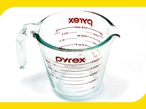 A glass pyrex measuring cup on a white background