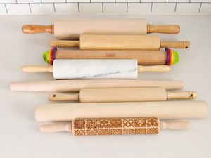 A variety of rolling pins on a counter