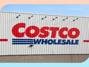 A Costco Wholesale sign on the side of a warehouse