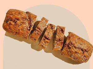 A loaf of sliced bread topped with slices sesame seeds