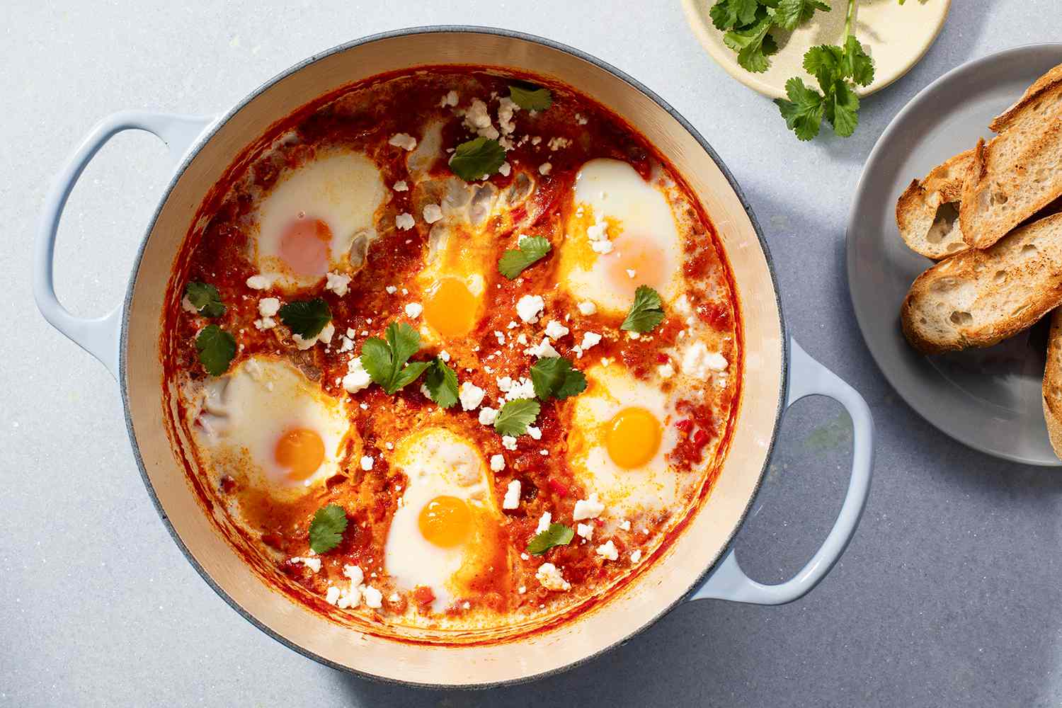 Shakshuka in a pot, served with toasted bread 