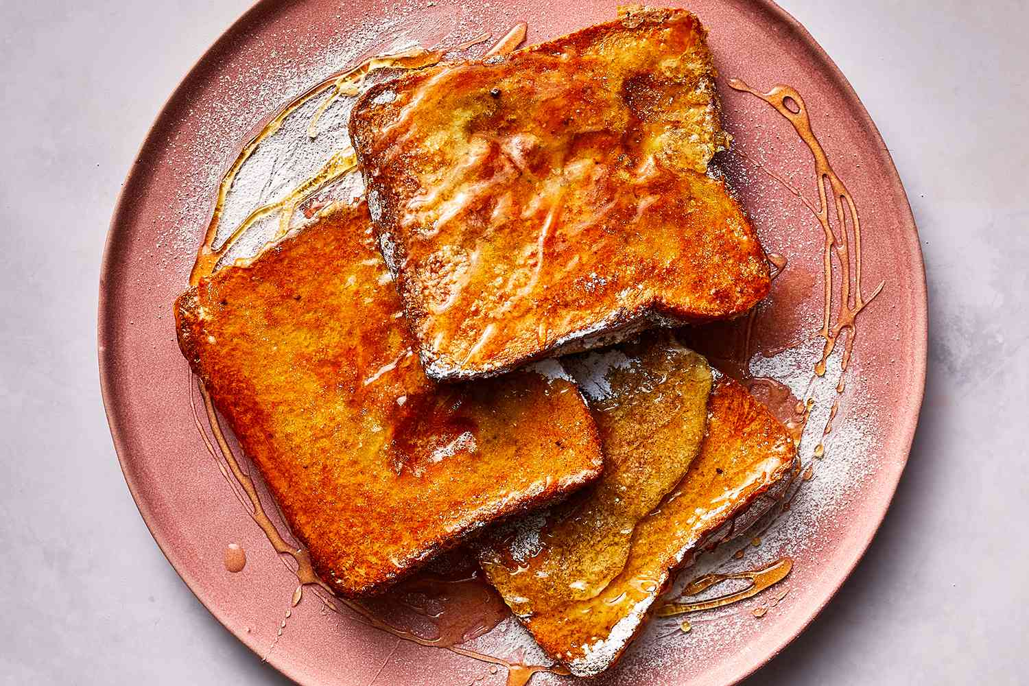 Sheet Pan French Toast topped with syrup on a plate