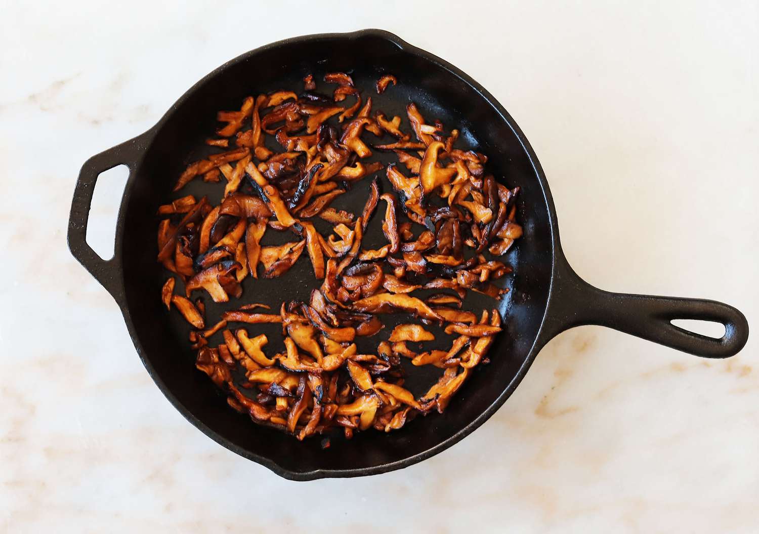 shitake bacon sautéed in a skillet