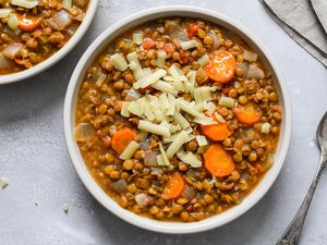 Slow cooker lentils garnished with cheese in a bowl