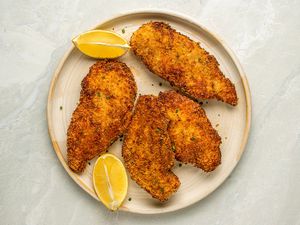 Sour Cream and Onion Chicken on a plate with lemon wedges 