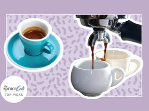 Espresso Machine pouring espresso into two cups next to a cup and saucer displayed on a purple patterned background