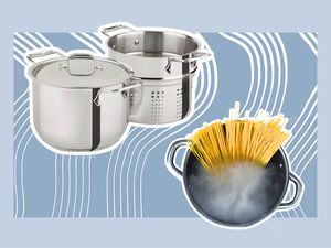 Assortment of pasta pots including pot of pasta with boiling water on blue background