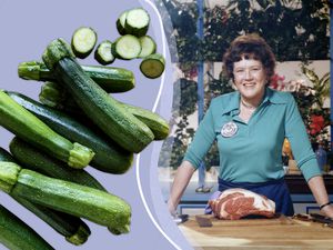 Julia Child next to a bunch of zucchini