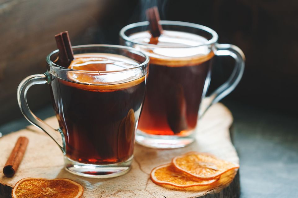 Two glasses of traditional mulled wine on a wooden surface