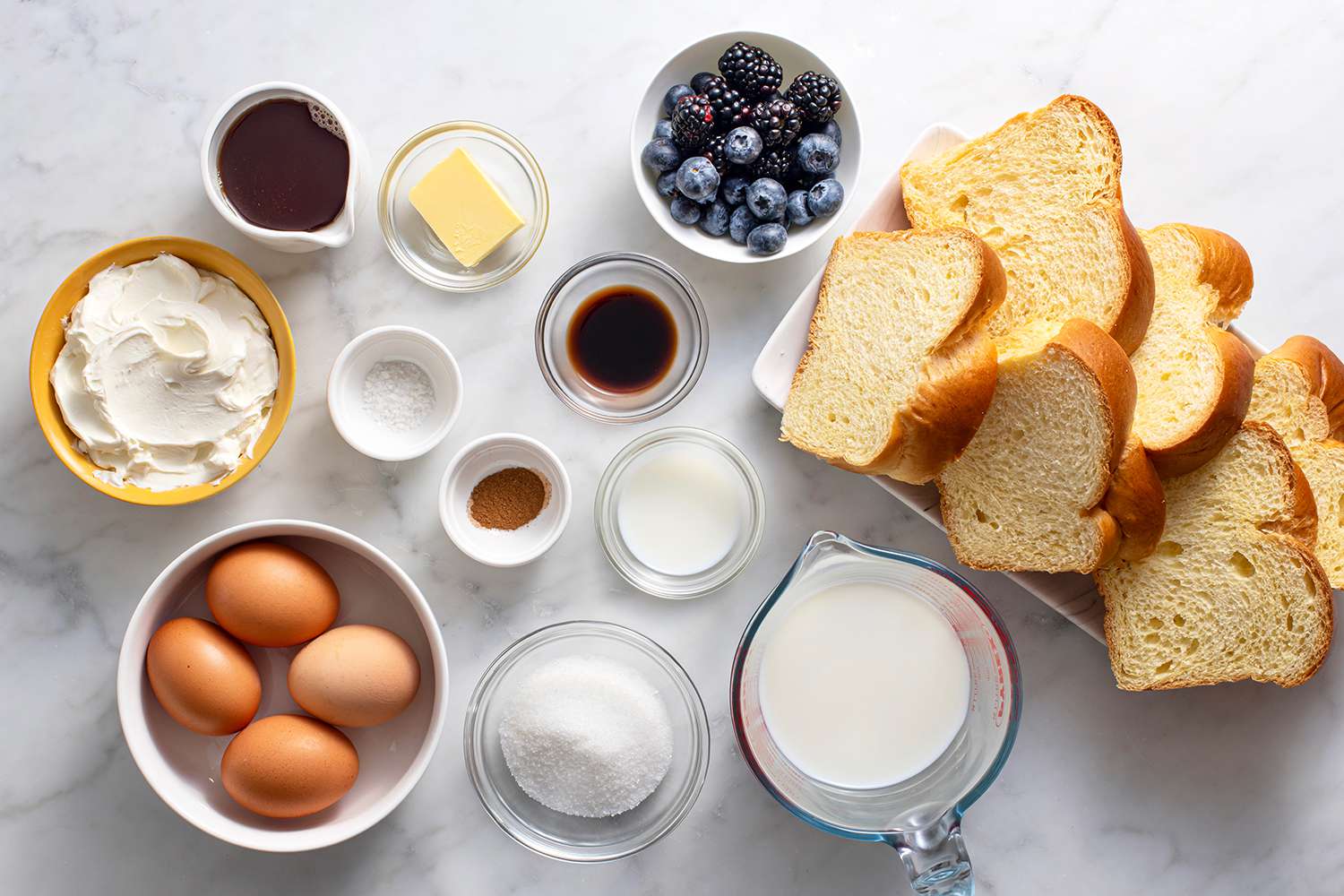 Ingredients for stuffed french toast gathered in bowls.