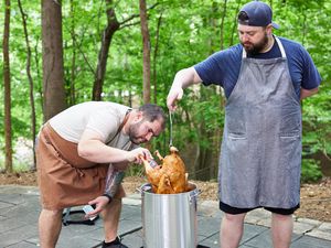 Testers examining a fried turkey in the King Kooker turkey fryer