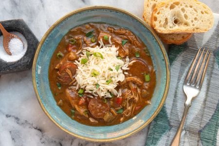 turkey gumbo in a bowl with rice and french bread