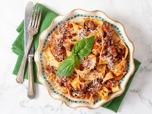 Turkey Bolognese in a bowl with basil garnish