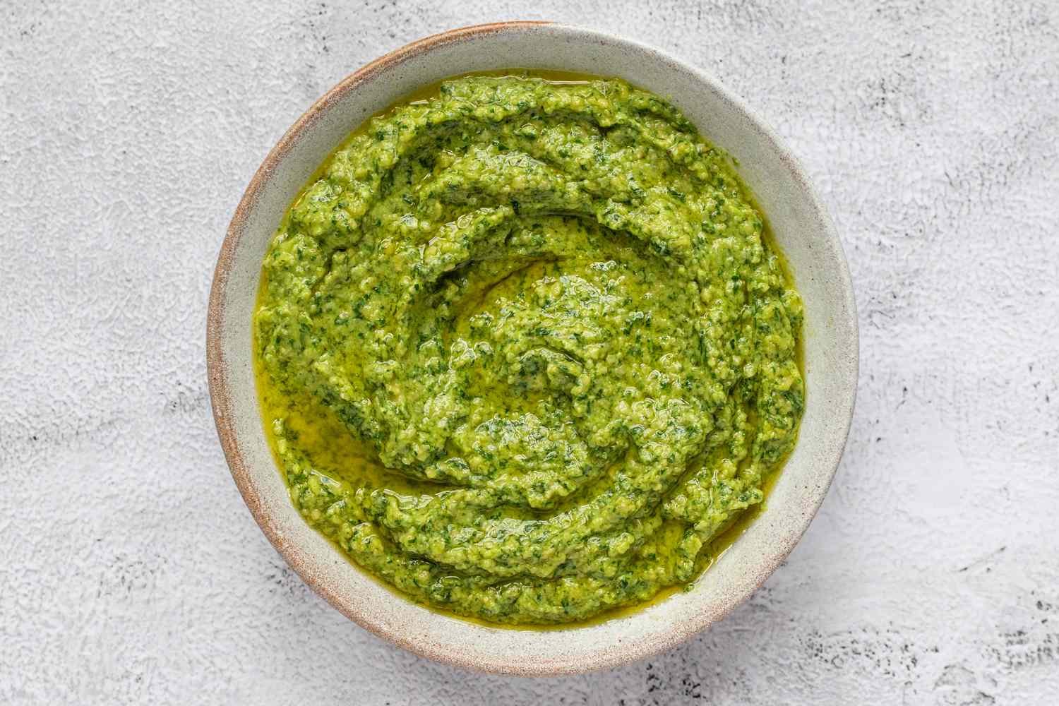 A vegan spinach cashew pesto sitting in a white bowl