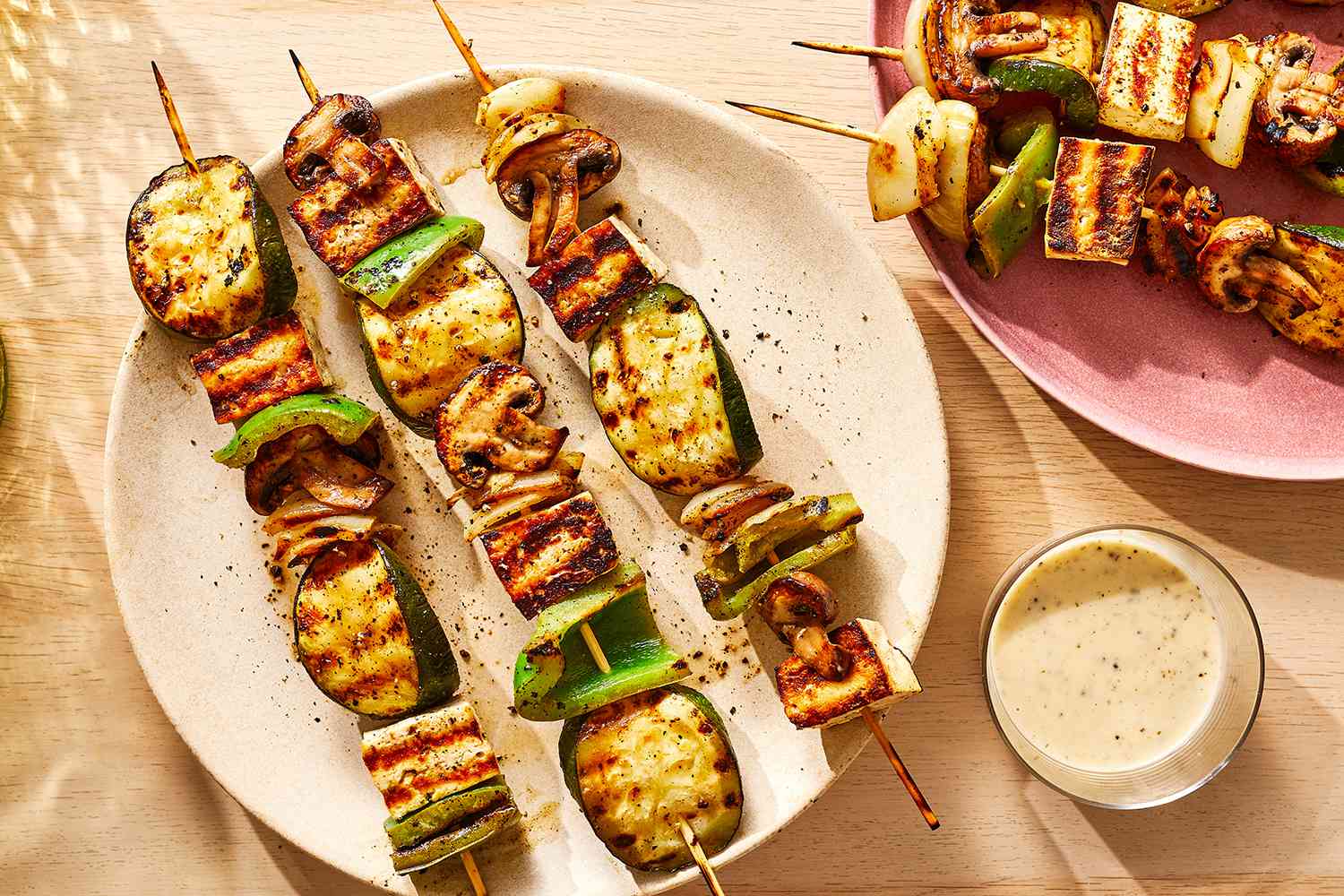 Grilled tofu and vegetable skewers on a platter