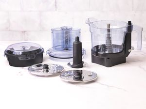 Vitamix Food Processor and accessories displayed on a marble counter