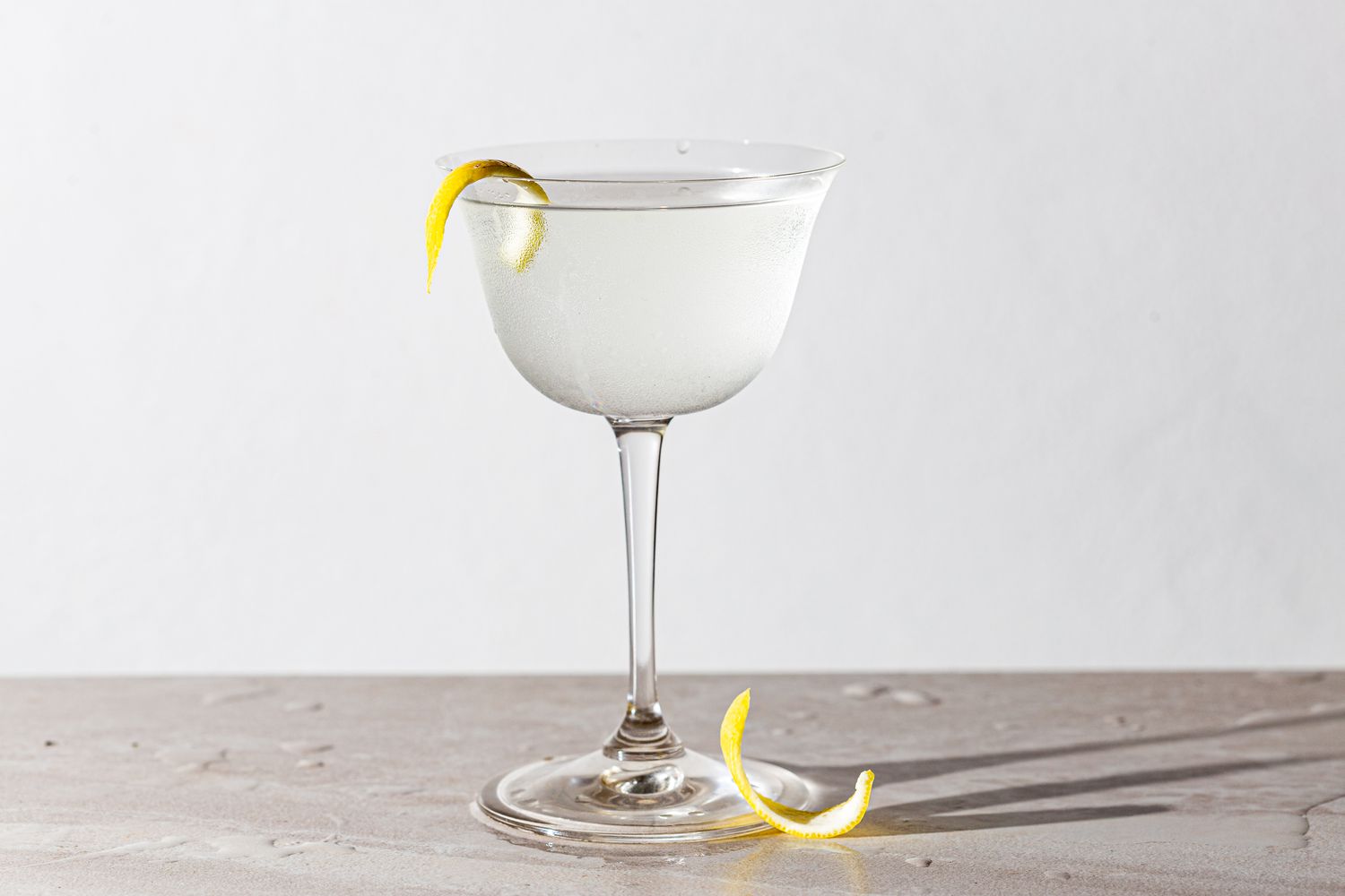 Vodka martini in a glass with lemon peel 