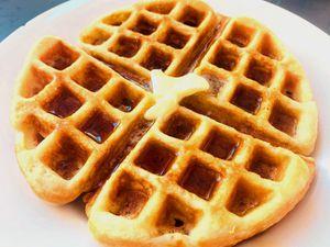 Close up of a waffle with melting butter on top