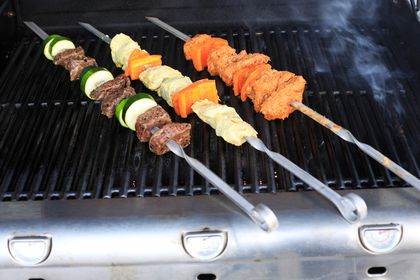 Timeless Steel Lula Kebab Skewers with meat and veggies cooking on a grill