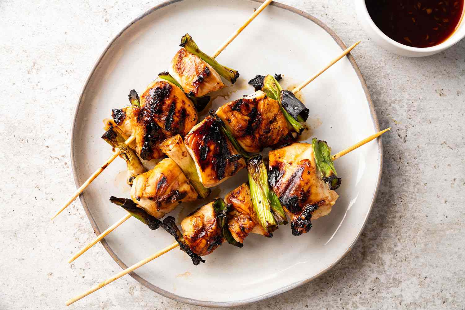 Yakitori Negima (Japanese Grilled Chicken and Scallion Skewers) on plates